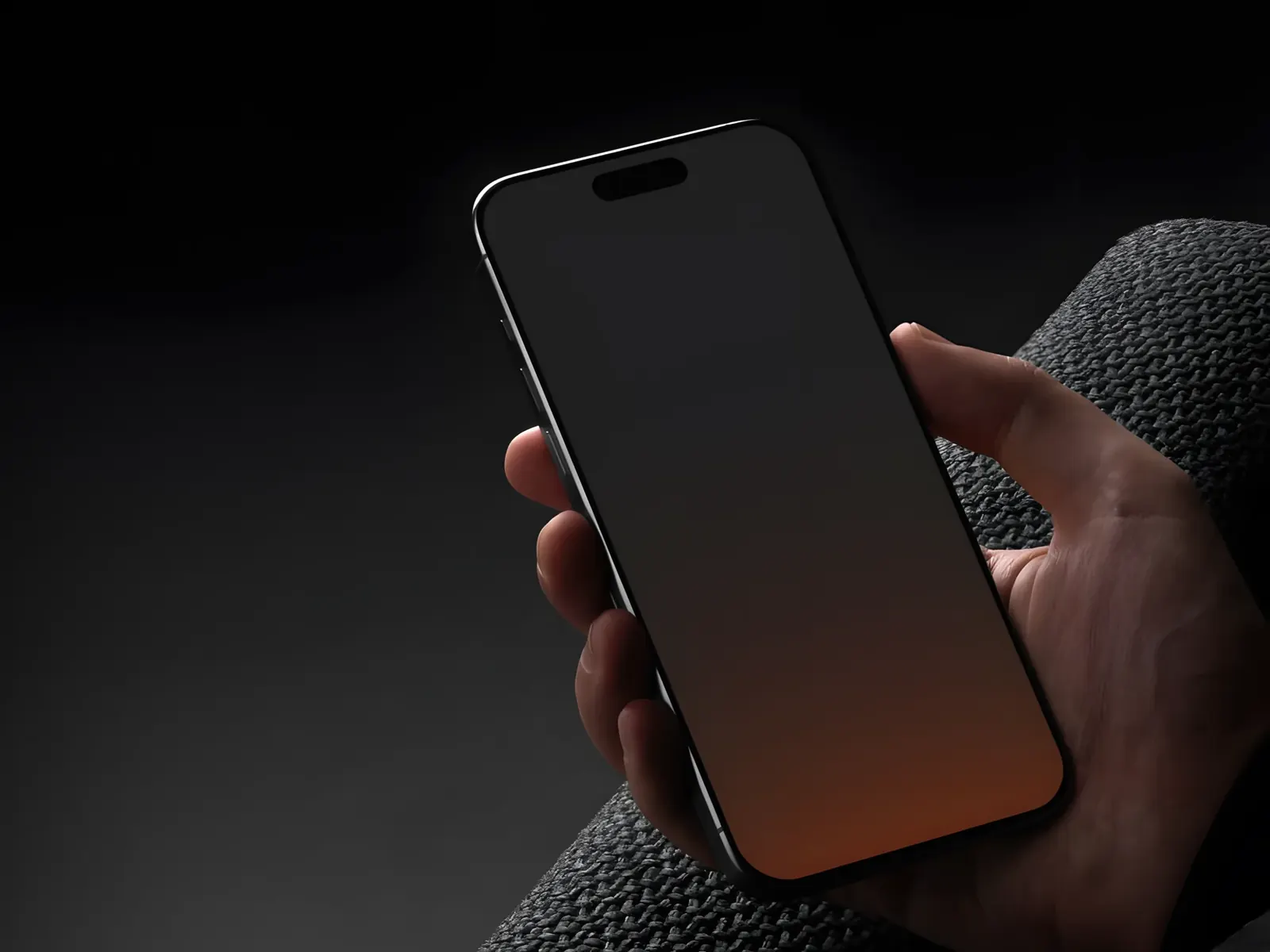 Hand holding a smartphone with a dark screen that glows orange at the bottom