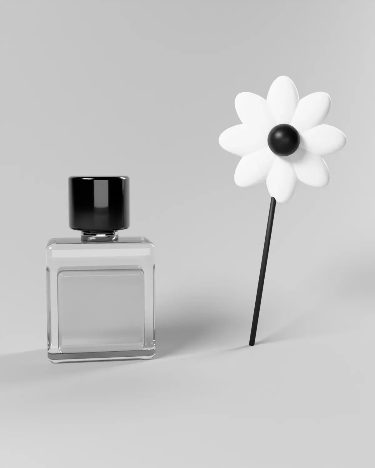 A perfume bottle beside a single white flower, in black and white