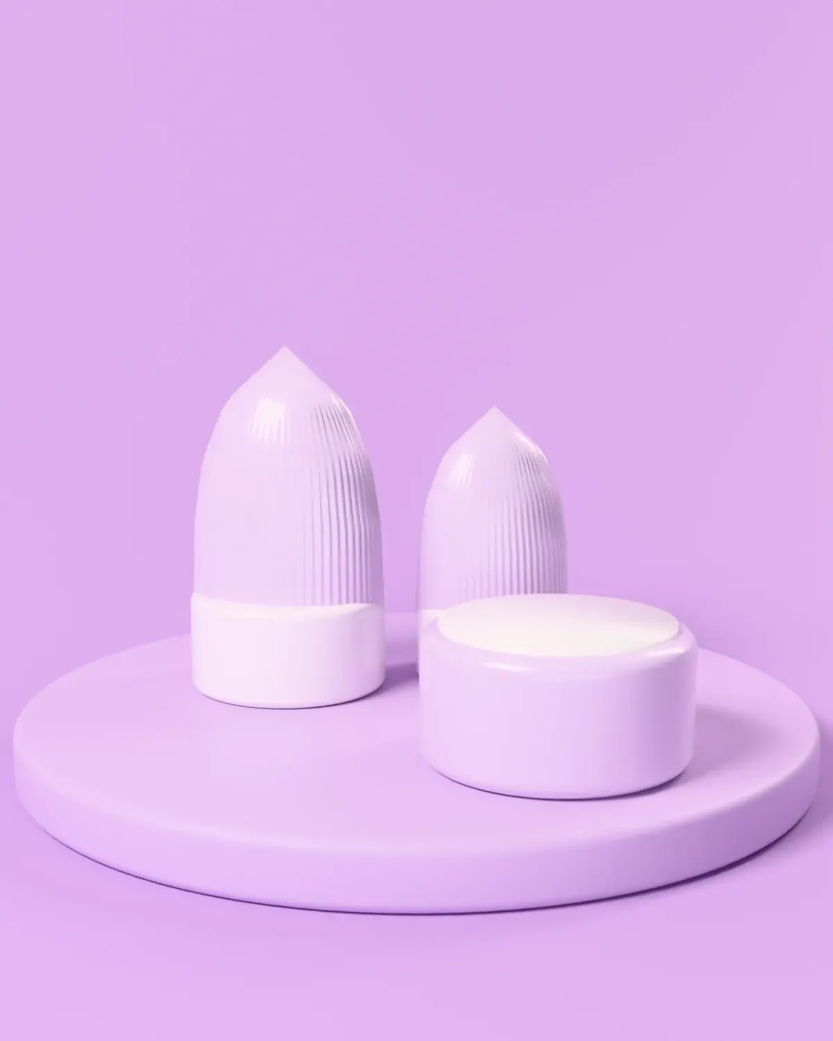 Two Cloudline tubes standing on their caps beside an open jar of cream