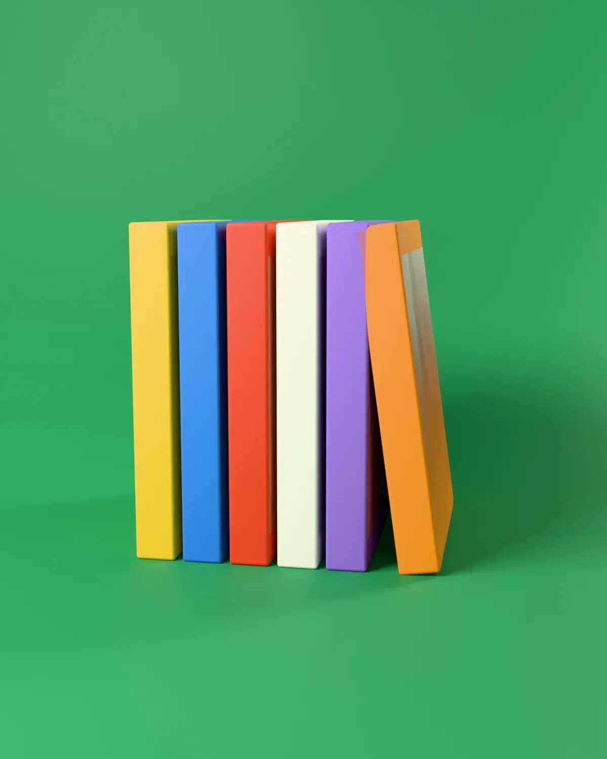 Fieldnote issues standing in a row like books on a shelf, on green